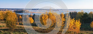 Panoramic view on Â autumn landscape - yellow forest and blue lakes.